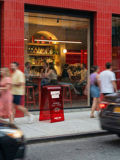 CHOUPA pavement sign in red acrylic in front of a cocktail bar.